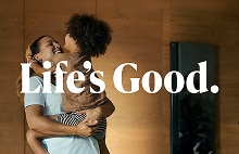 A smiling mother happily hugging her child in front of an LG Styler, with "Life's Good." text overlay.
