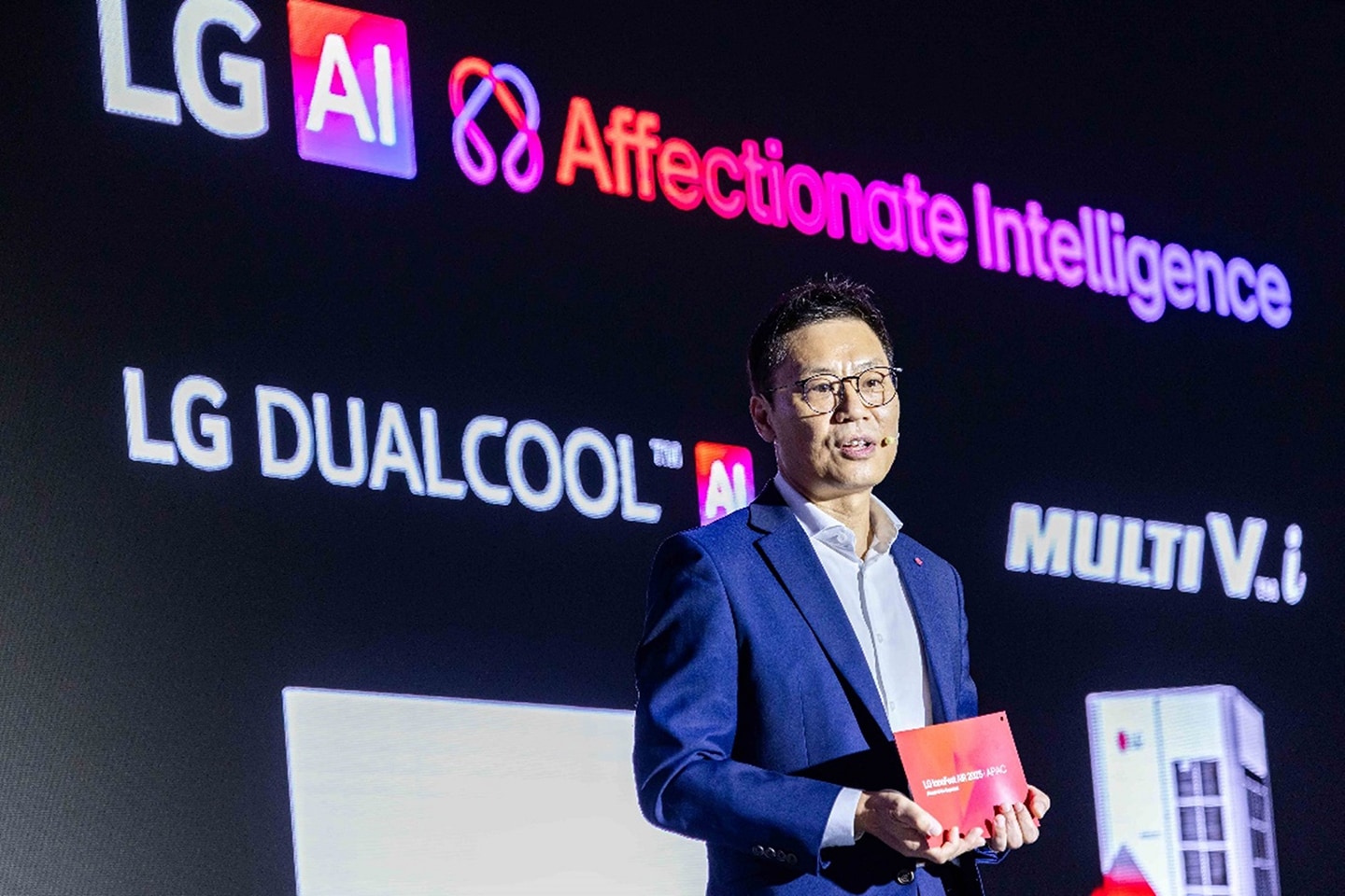 A photo of a man speaking in a conference