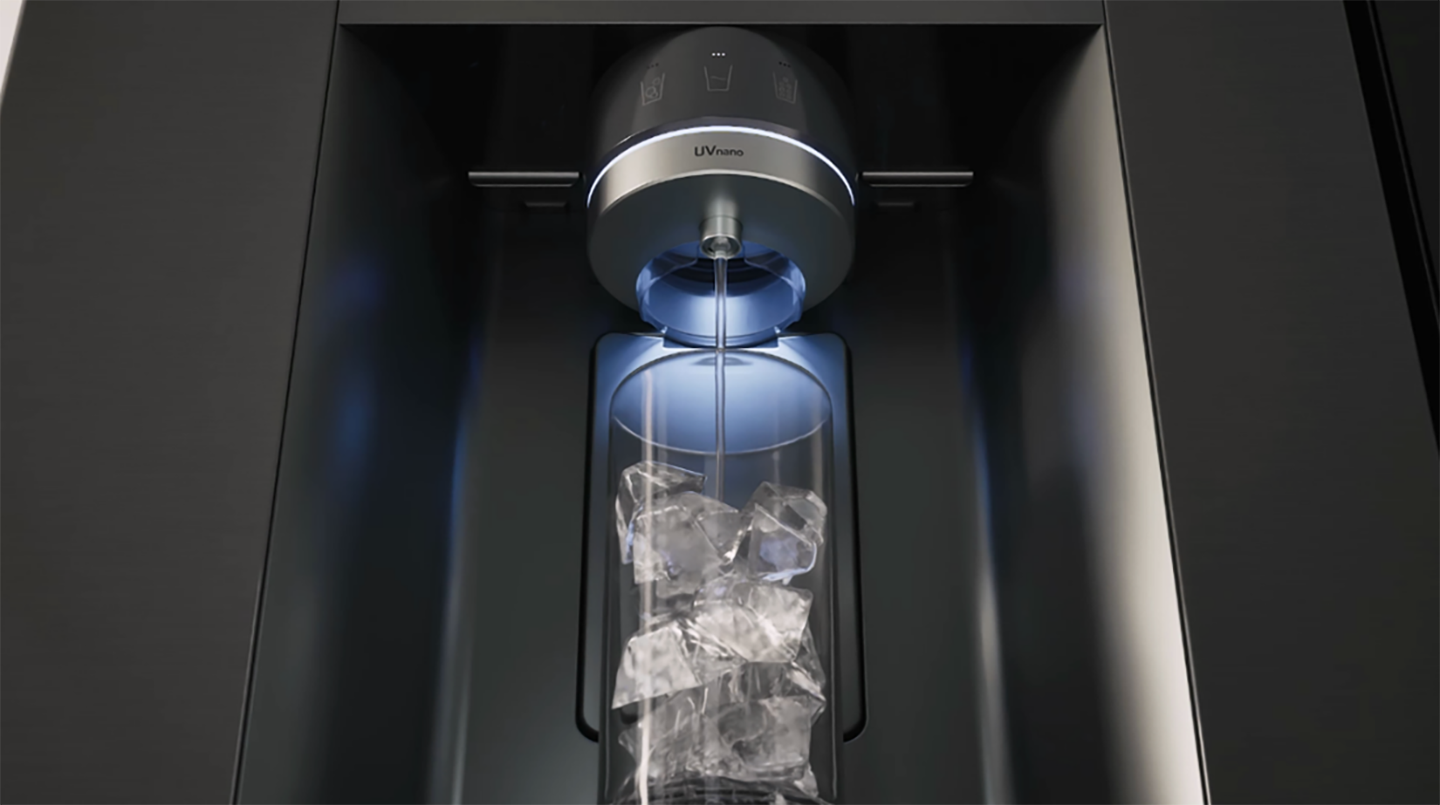 A photo water dispenser pouring water to a glass cup