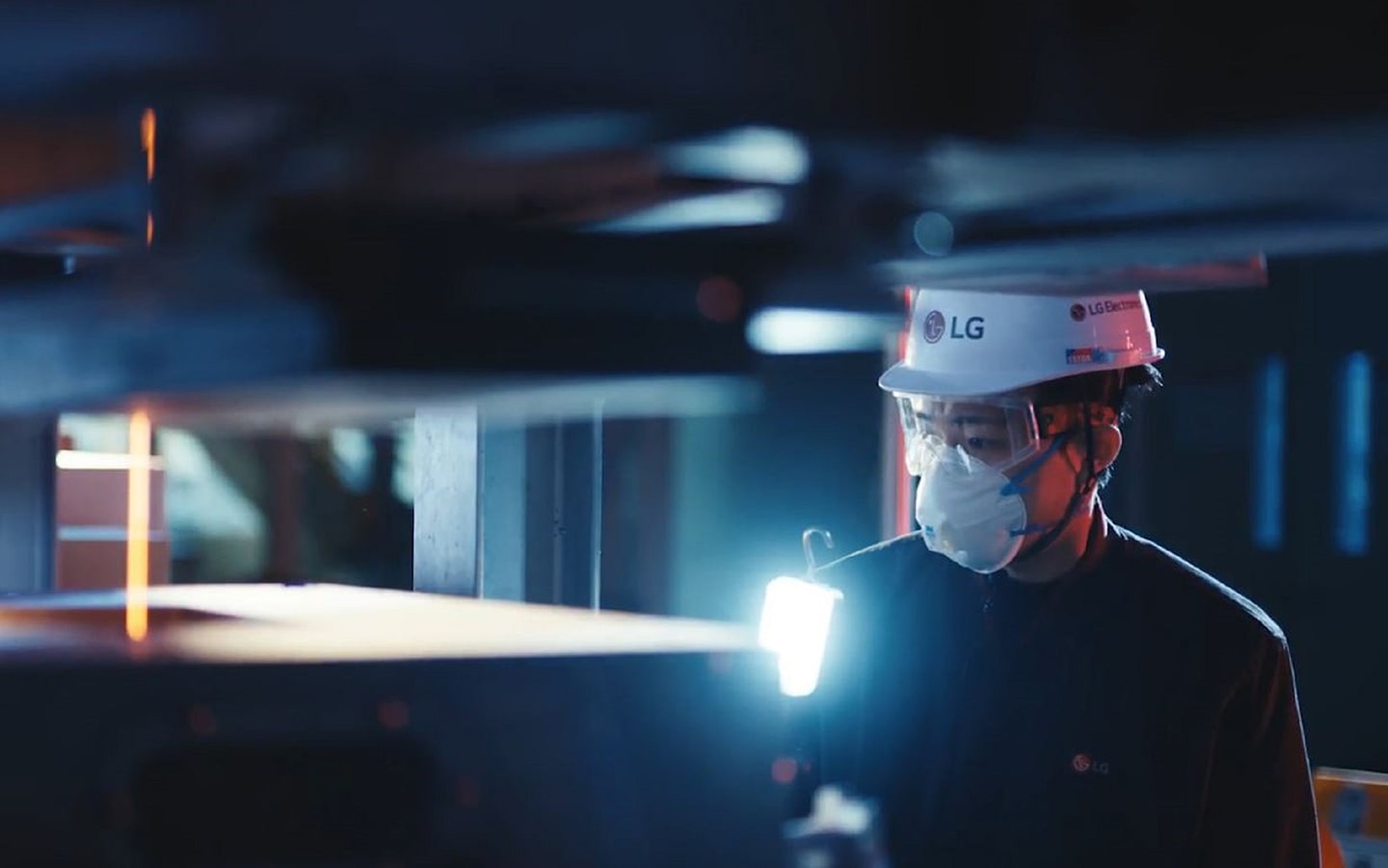 A photo of a factory worker observing a flat surface