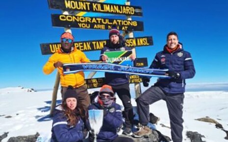 Members of FC Cambounet pose for a group photo at the peak of Mount Kilimanjaro.