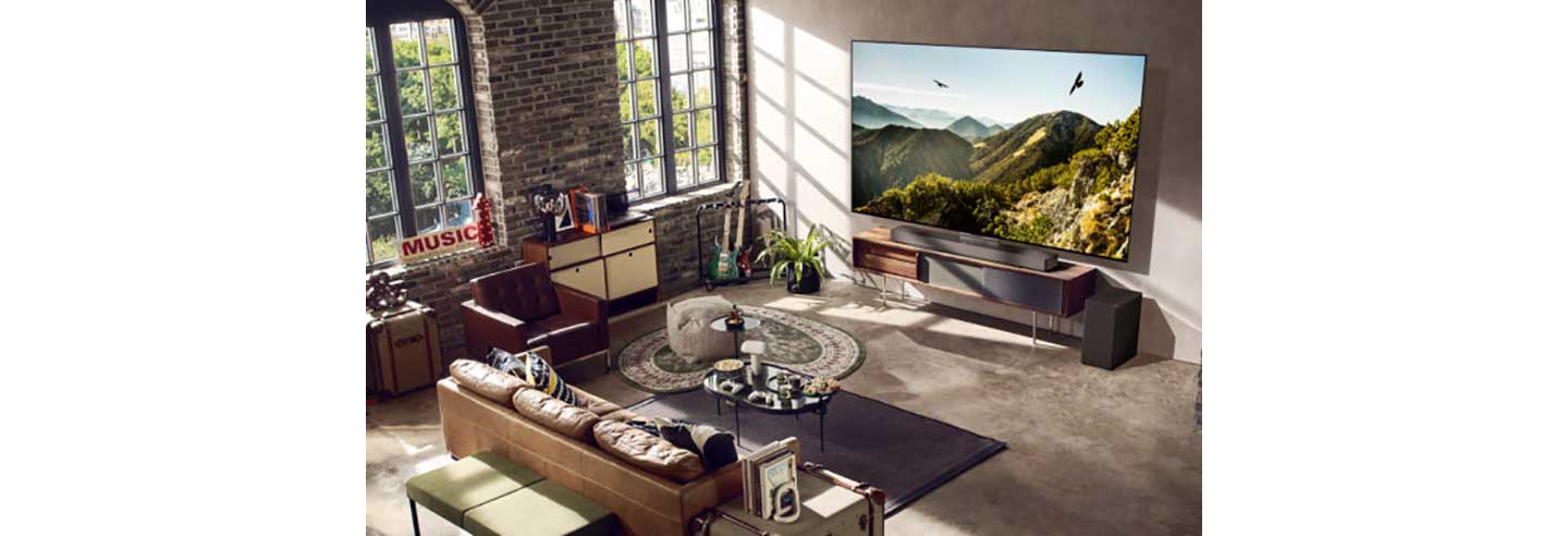 A 2023 LG OLED evo TV in a neatly organized living room with a variety of furniture
