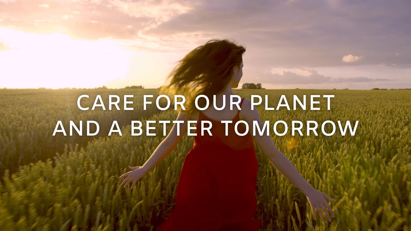 A girl in a red dress running through a field with the phrase