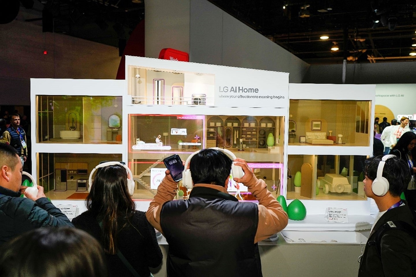 A photo of people in the Rise & Shine (LG AI Home) zone with their headsets on listening to the explanation 