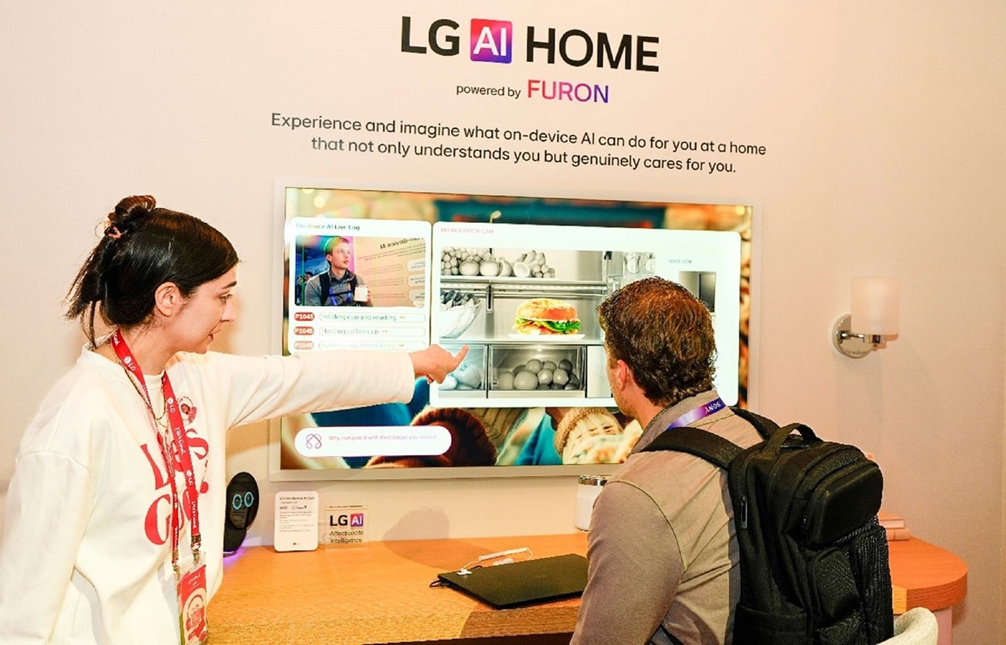 A photo of a person explaining LG AI Home Powered by FURON at The Rise & Shine zone and a person listening to the explanation