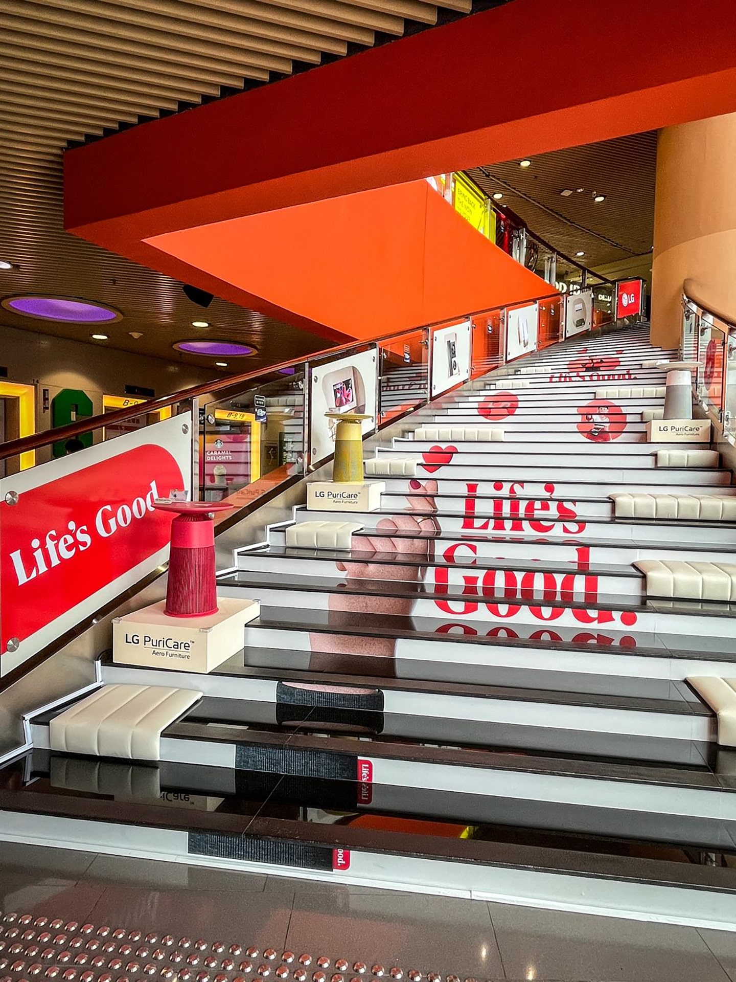 A picture of the Life's Good Zone stairway with multiple products displayed at MegaBox mall