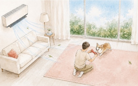 Watercolor and ink illustration on textured cream paper, wide horizontal crop, no text overlay. A living room with a white wall-mounted air conditioner blowing pale blue air streams and loose leaves across the room. A cream sofa with a coral cushion sits against the left wall beside a small round side table with a lamp and potted plant, and a framed landscape picture hangs above. A wooden bookshelf with wicker baskets, plants, and framed photos stands on the right. In the center, a large sliding glass door with sheer curtains reveals green treetops under a blue sky. On a pink area rug in the foreground, a man with short dark hair, wearing a light shirt, beige pants, and white sneakers, kneels playing with a corgi dog, holding a red toy between them. 