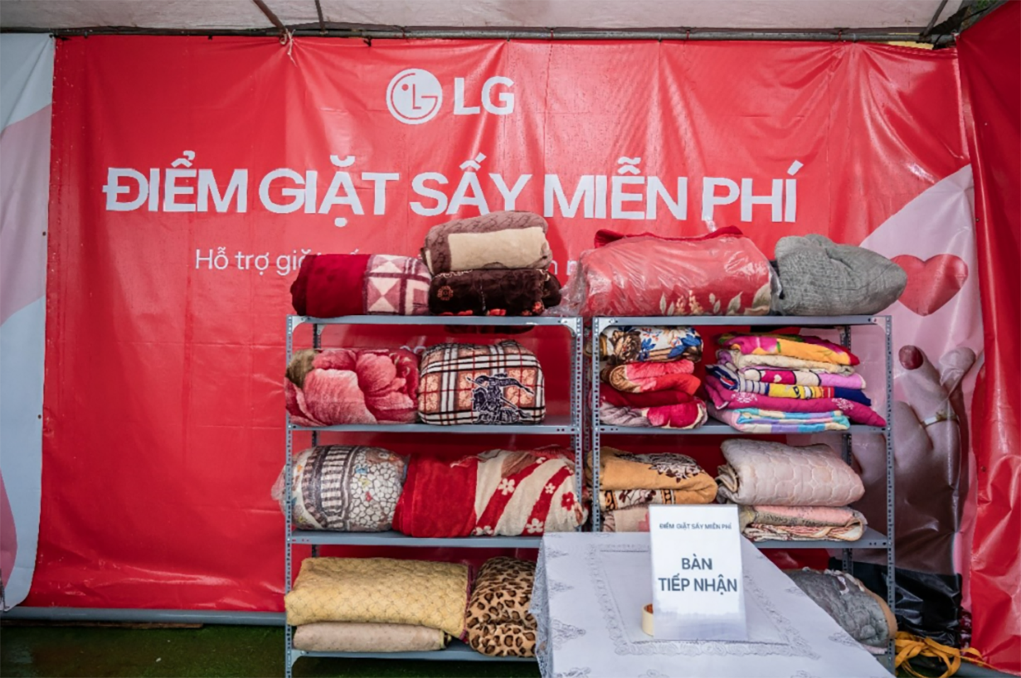 A photo of various blankets folded up and organized in an open storage cabinet 