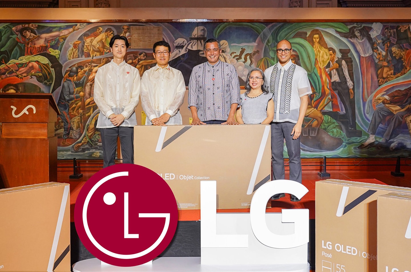 A photo of five people smiling behind an LG OLED TVs donated to a museum 