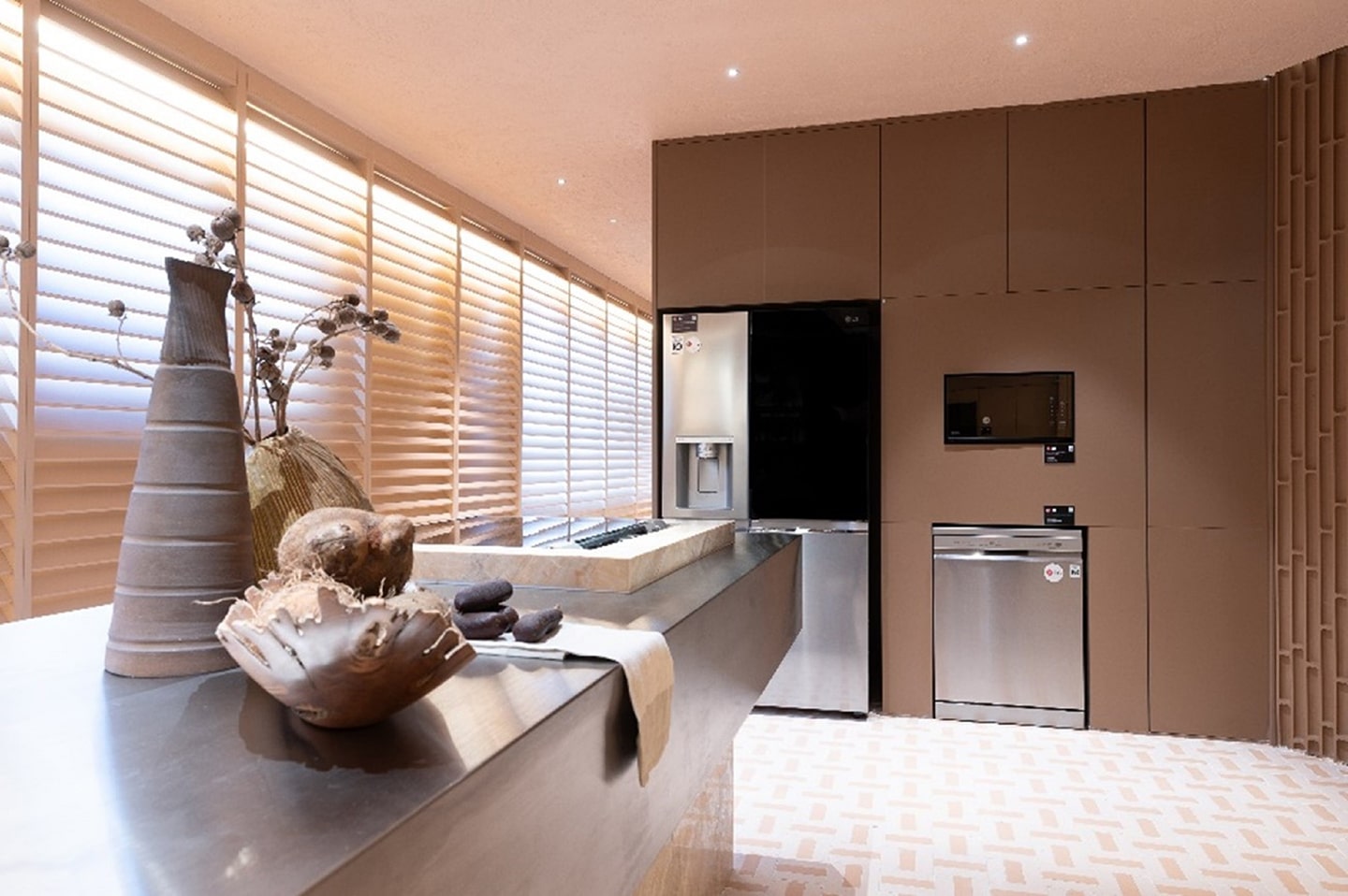 A picture of a kitchen area with LG InstaView Side by Side refrigerator with Craft Ice