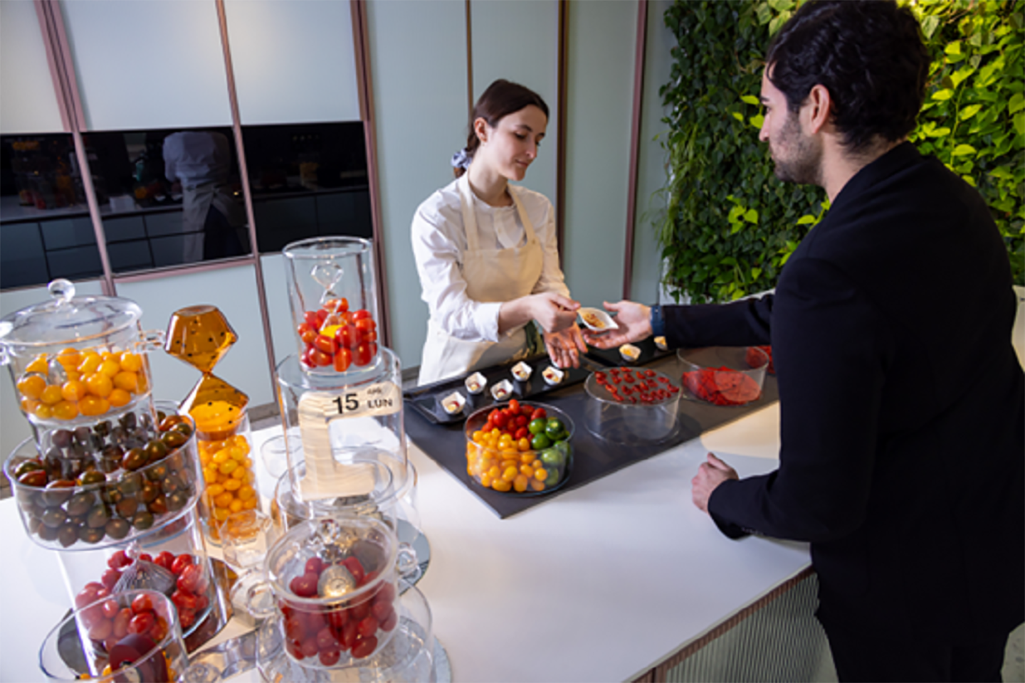 A picture of a person receiving finger food at the showroom venue