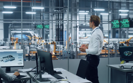 A worker looking over the production process of machines
