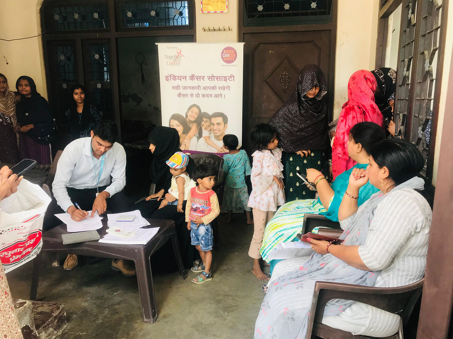 A picture of adults and children at the area of the program