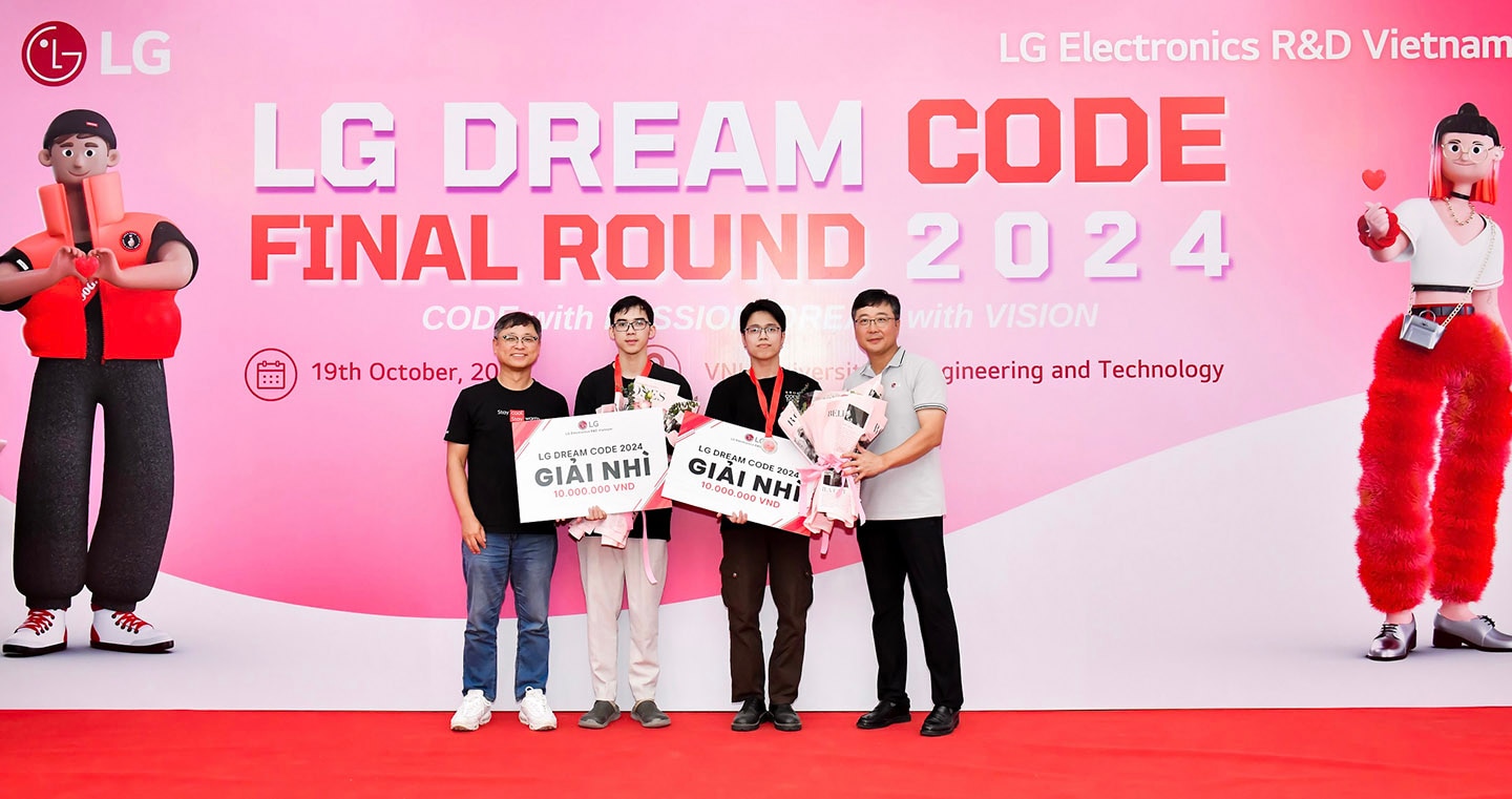 A photo of two winners from the final round of LG Dream Code 2024 and two LG officials smiling with their medals and prizes in front of the photo zone