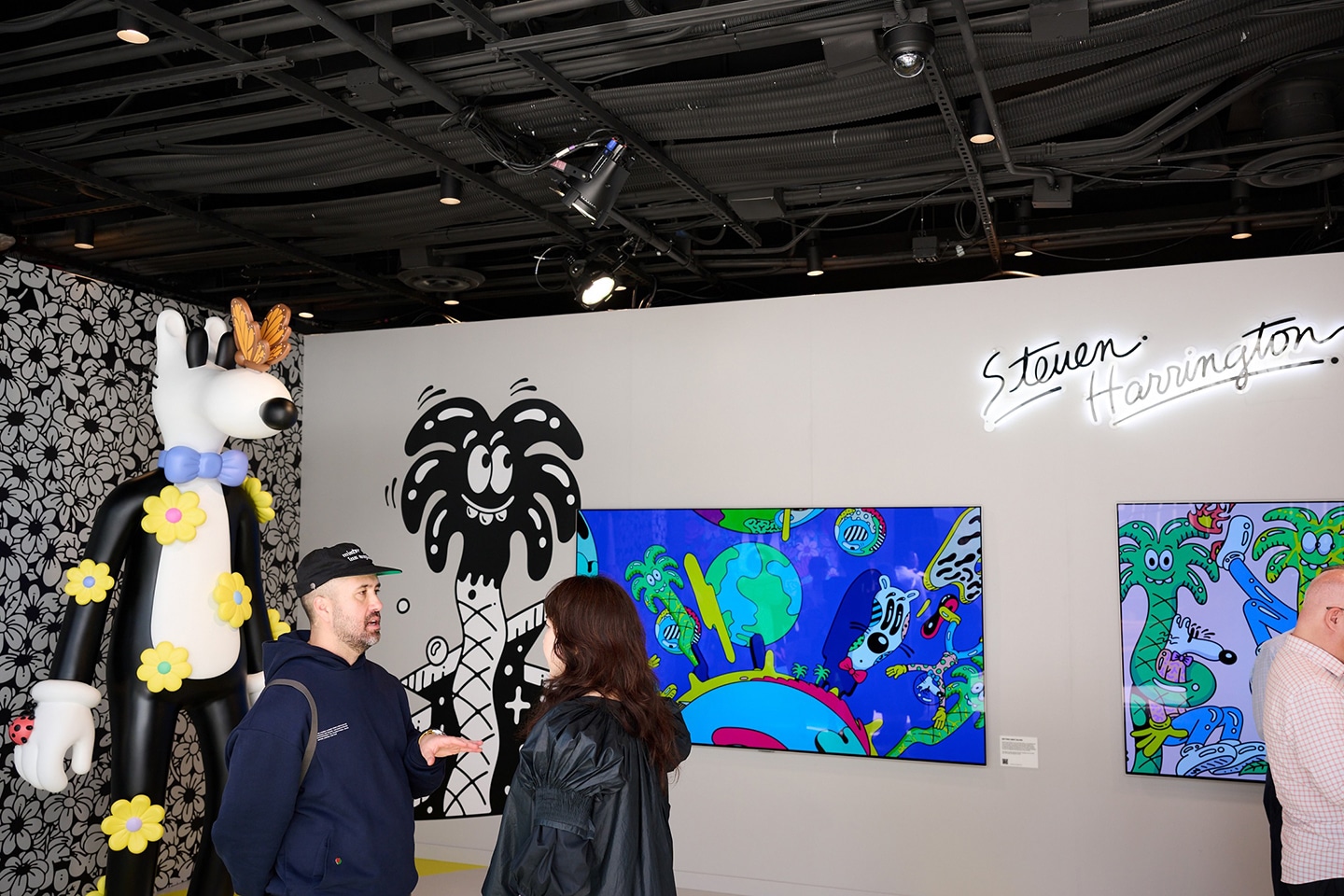 A photo of a man explaining about the artwork to a woman