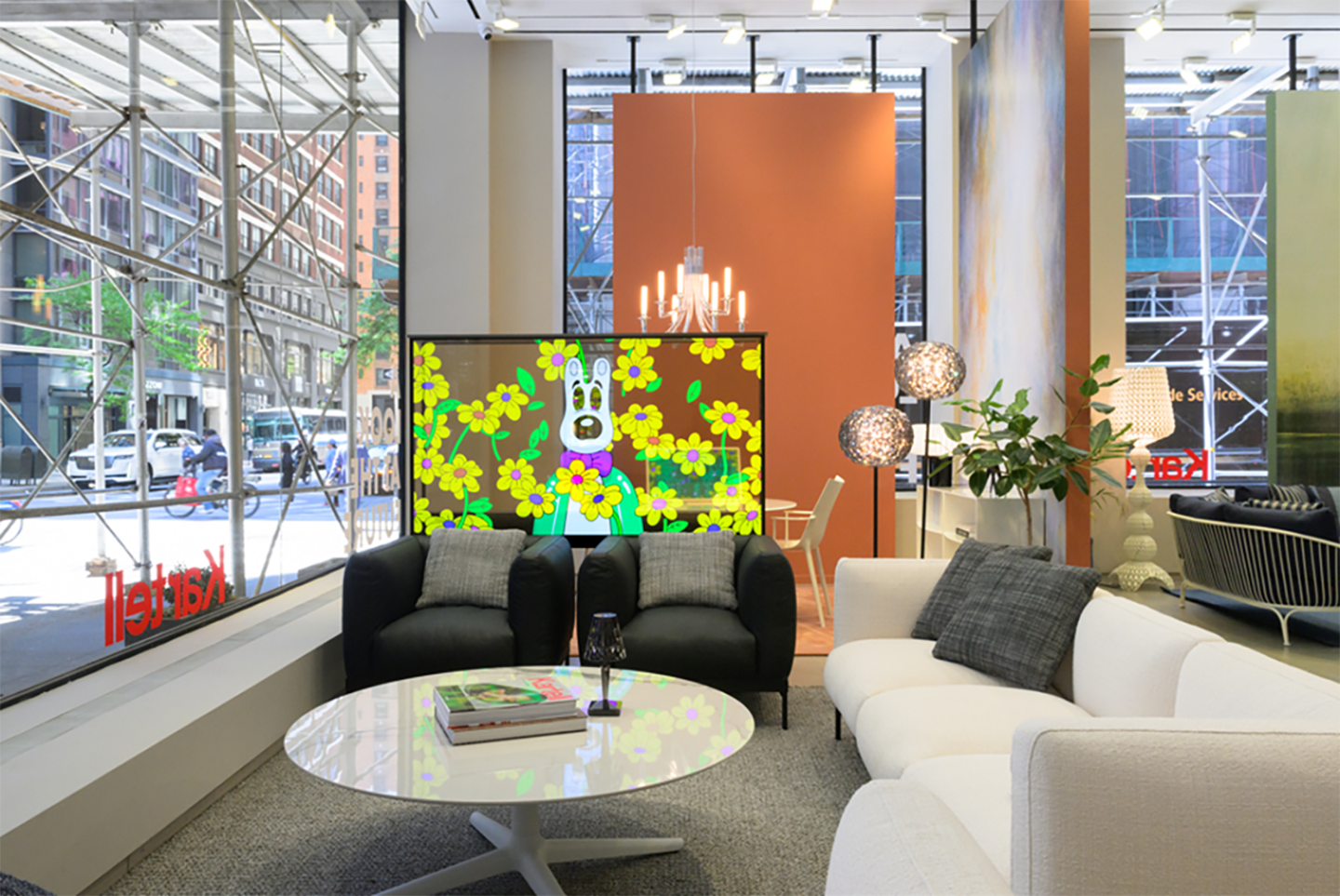 A photo of a lobby with couches and an OLED TV showcasing an artwork at the center