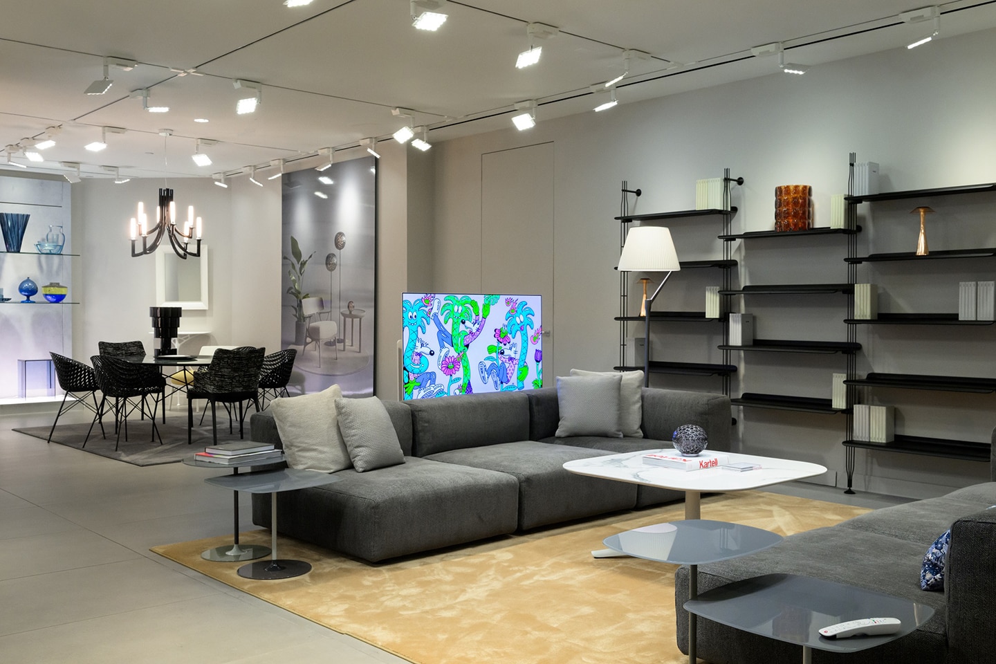 A photo of a room with couches and an OLED TV showcasing an artwork at the center