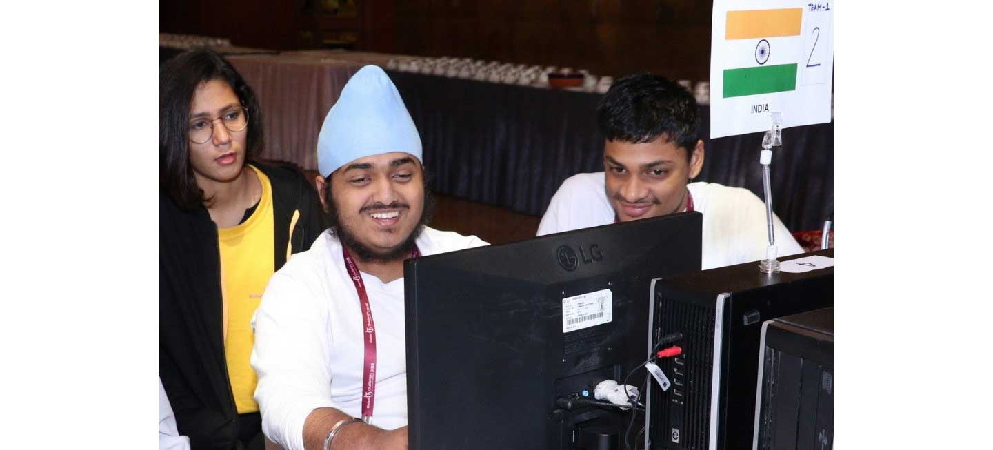 Members of the India team smile while looking at the LG monitor