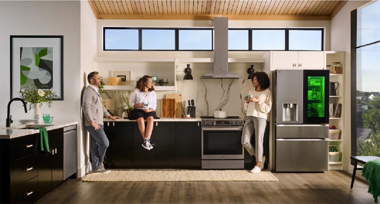 A picture of three people in a kitchen area