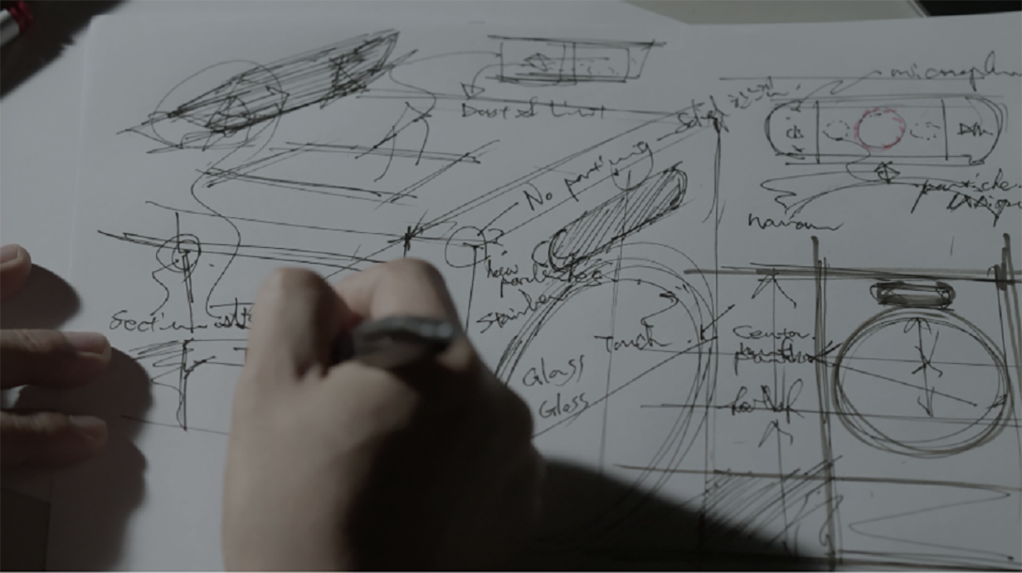 A picture of someone drawing sketches on paper