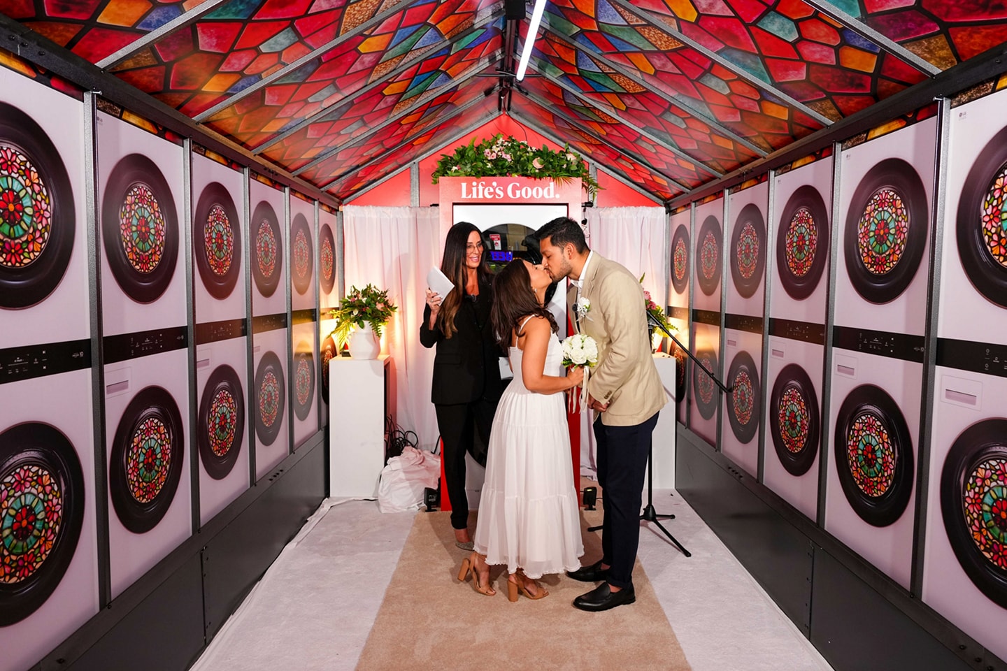A couple kissing inside a small wedding venue