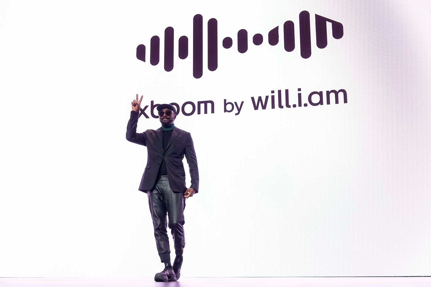 A photo of will.i.am smiling and posing during the LG World Premiere press conference at CES 2025
