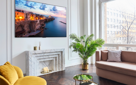 A 2023 LG OLED TV mounted on the wall of a bright, modern living room