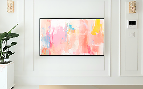 An image of an OLED TV in a home-like setting with artwork displayed on the screen