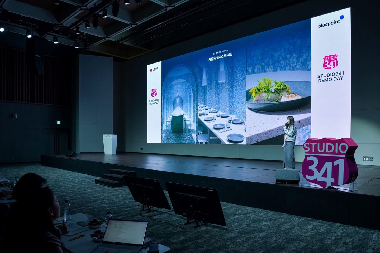 A photo of Found Objet Founder Kim Ju-hee speaking on stage with a microphone 