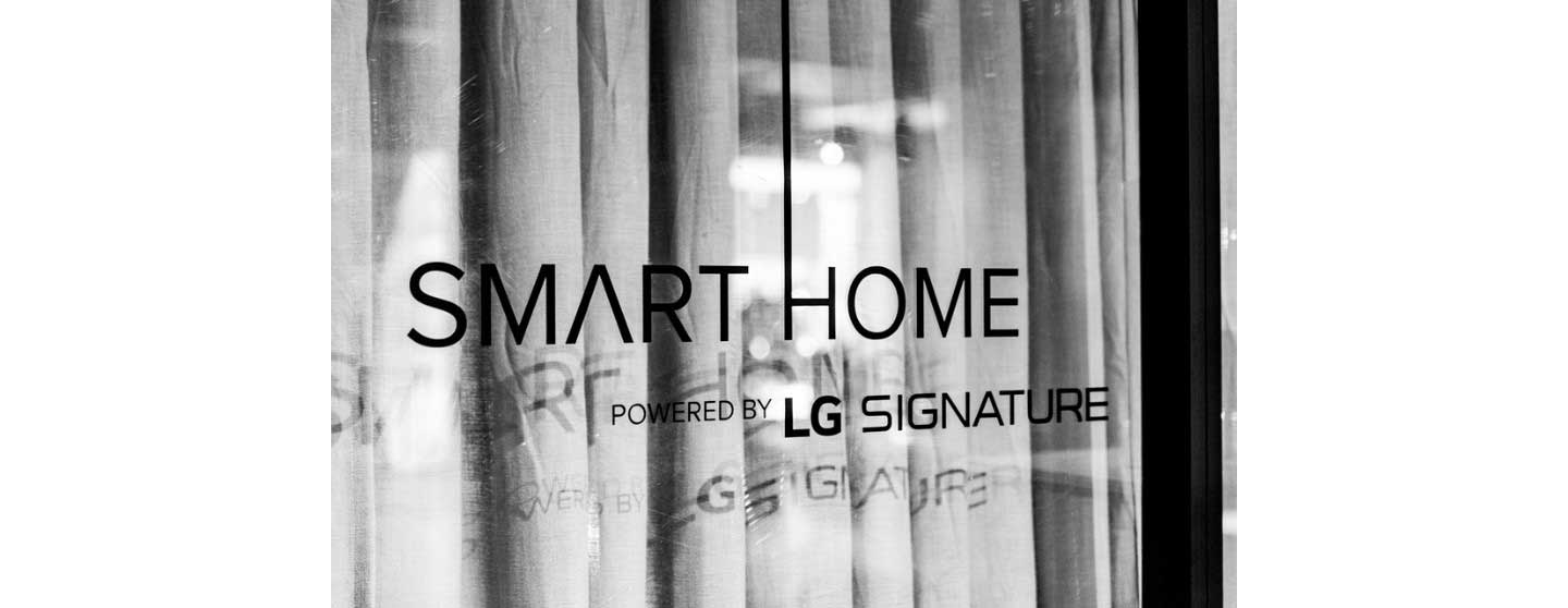 The logo of the “Smart Home powered by LG SIGNATURE” attached on the glass at the event zone