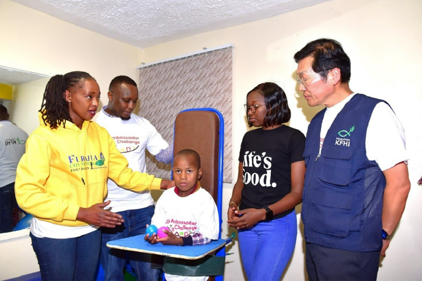 A picture of LG East Africa employees aiding children with disabilities