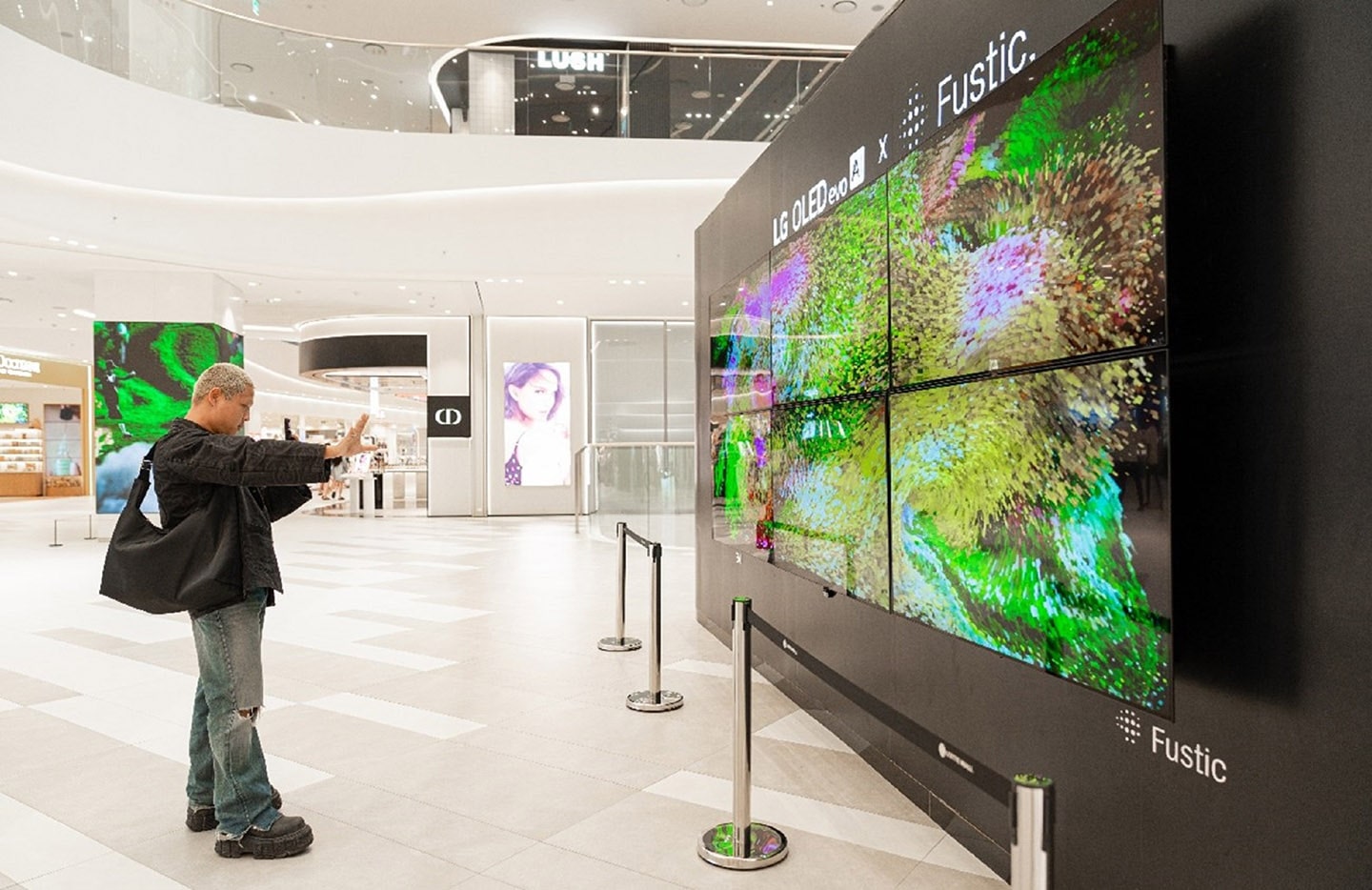 A photo of a man looking at a digital art exhibition