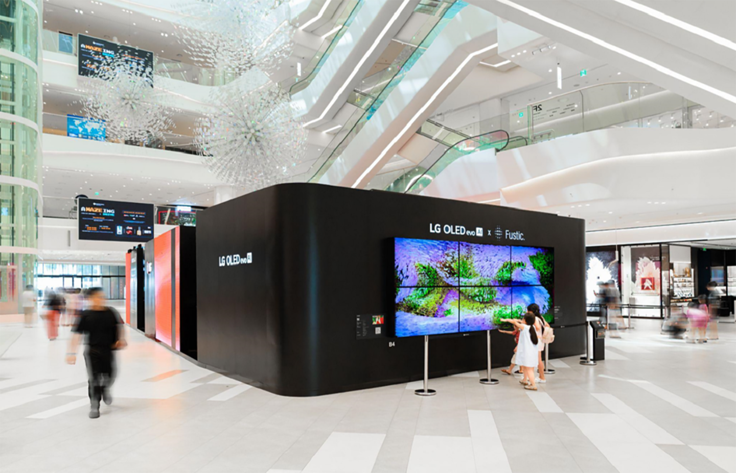 A photo of the exhibition in the mall with people walking by  