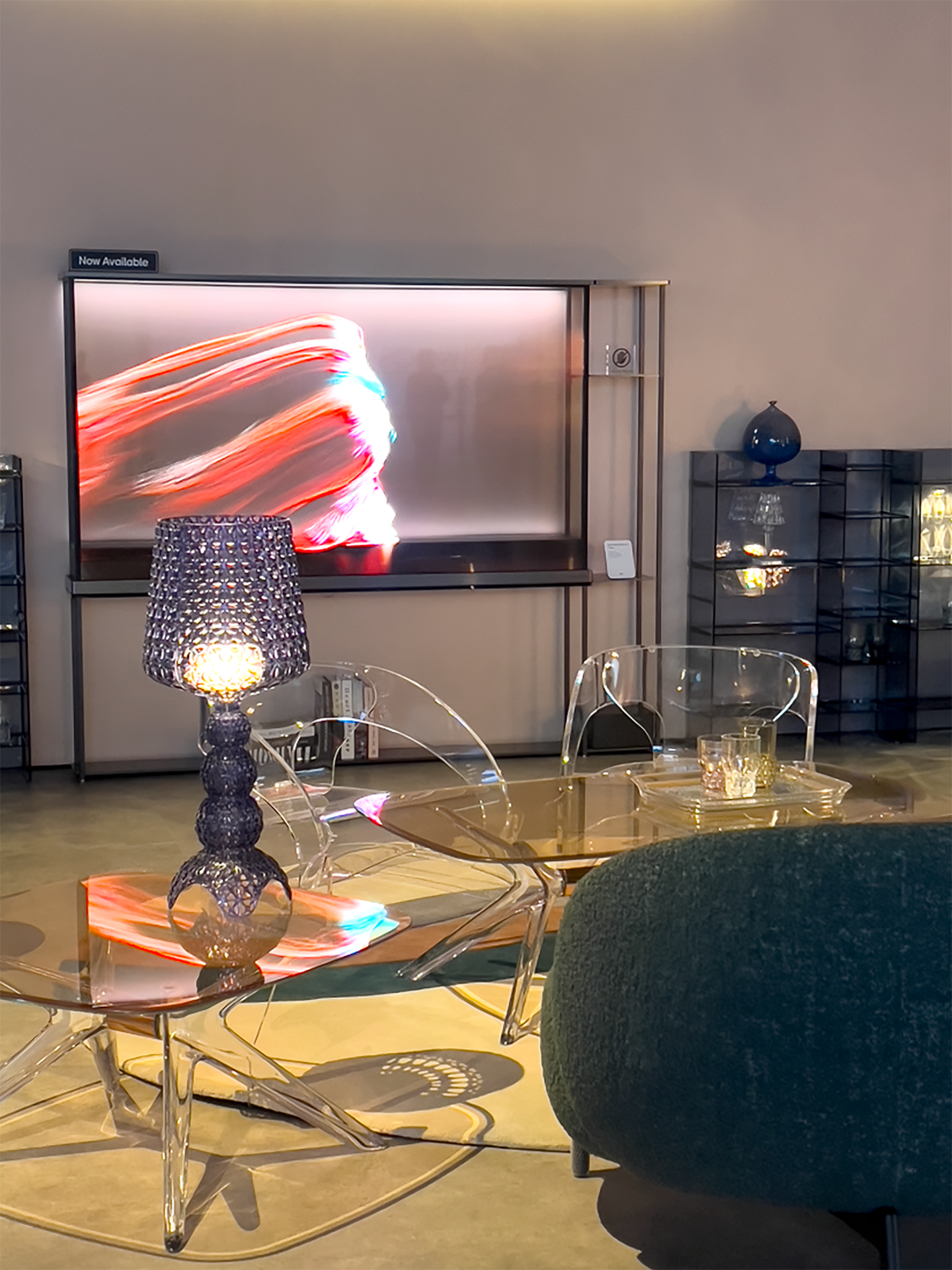 A picture of a living-room like area with Kartell products and LG Signature OLED T in the back