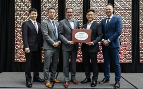 LG executives, including Brad Oh, President of LG Vehicle Solution USA (fourth from left), are pictured with Toyota executives alongside the 2024 Toyota 'Excellent Value Improvement Award'