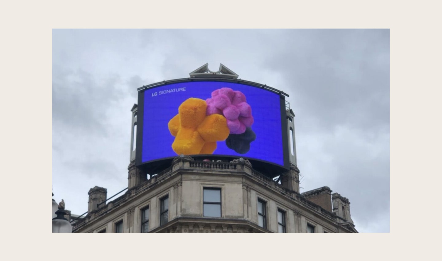 A close-up photo of LG's digital billboard in Piccadilly Circus, London with an animation representing LG SIGNATURE Washer and Dryer