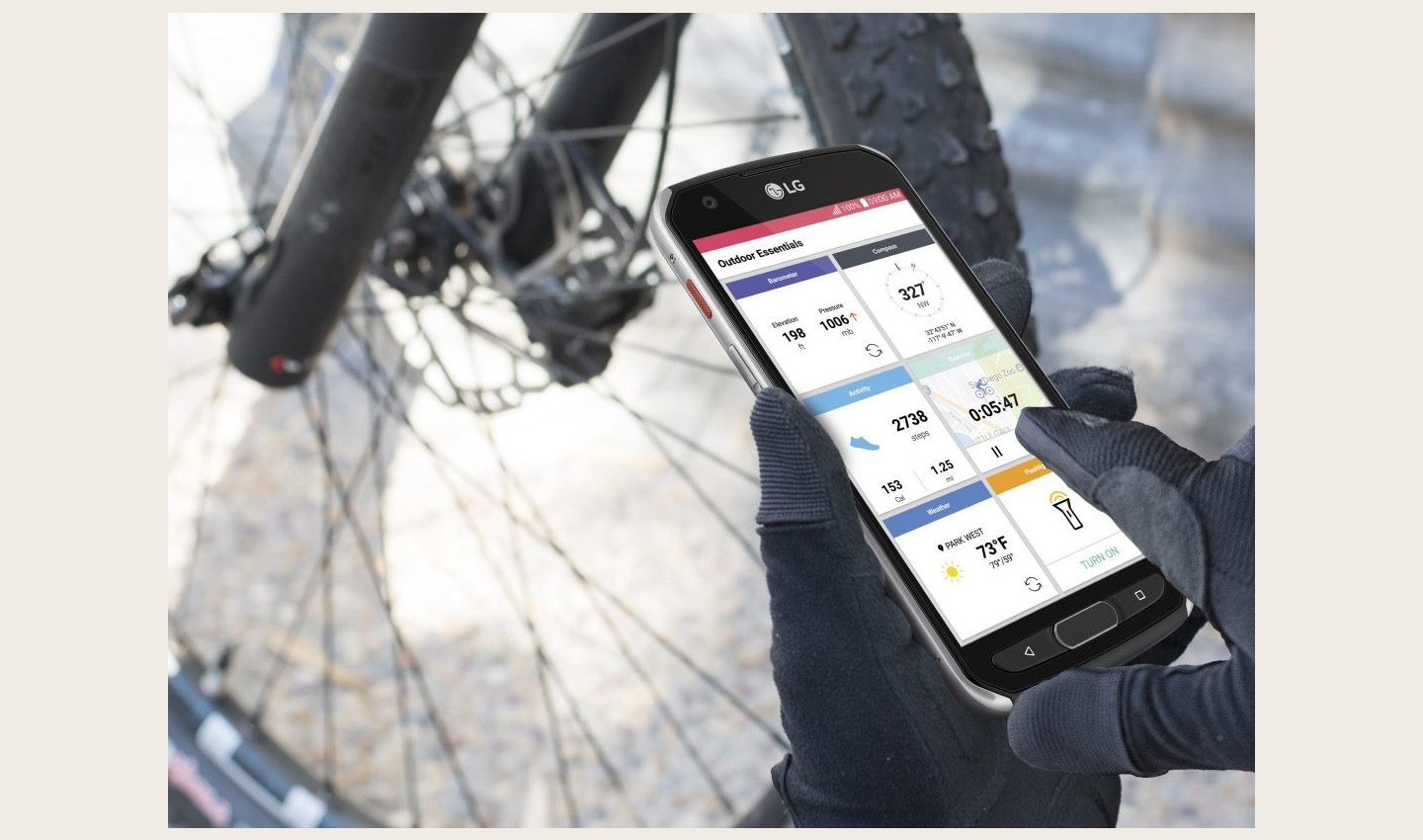 Close-up view of a person’s hands while they are using the LG X Venture to check the Outdoor Essentials
