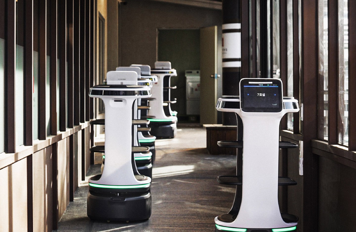 A photo of several LG's AI-driven autonomous service robots in the hallway