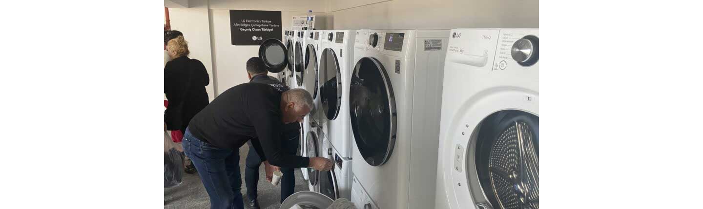 A man trying to use LG washer and dryer installed at free laundry facility that LG built to support victims of disastrous earthquake in Türkiye