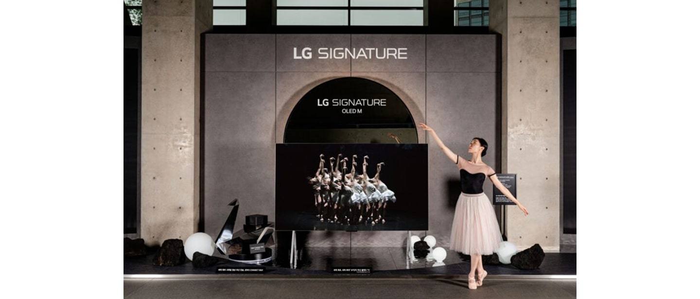 A ballerina posing next to LG SIGNATURE OLED M installed at LG Arts Center SEOUL