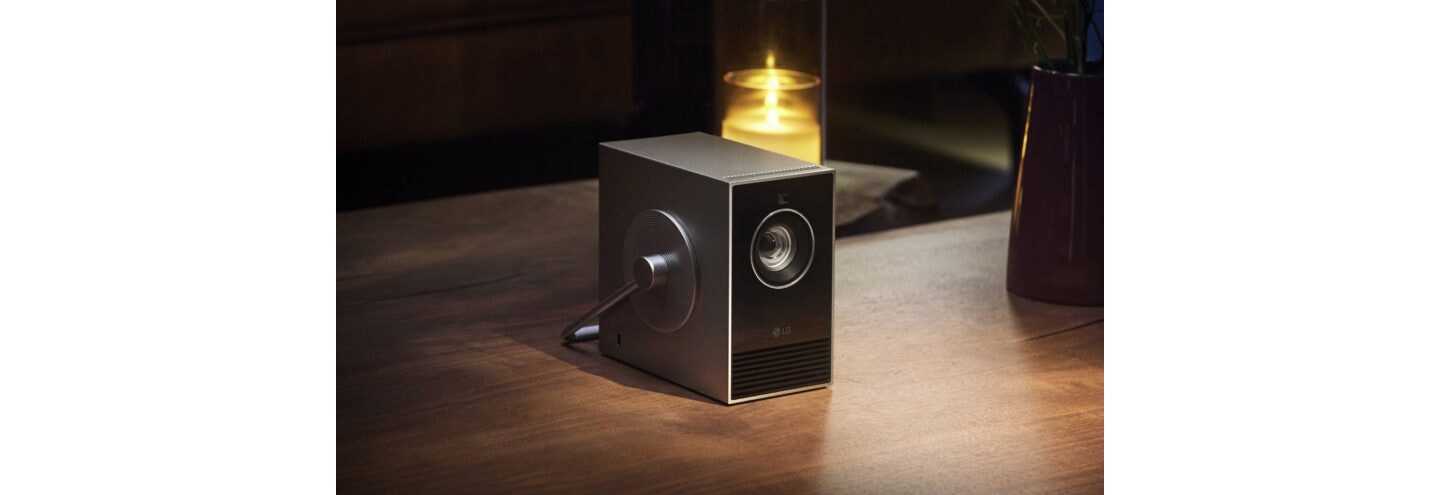 LG CineBeam Qube placed next to a candle