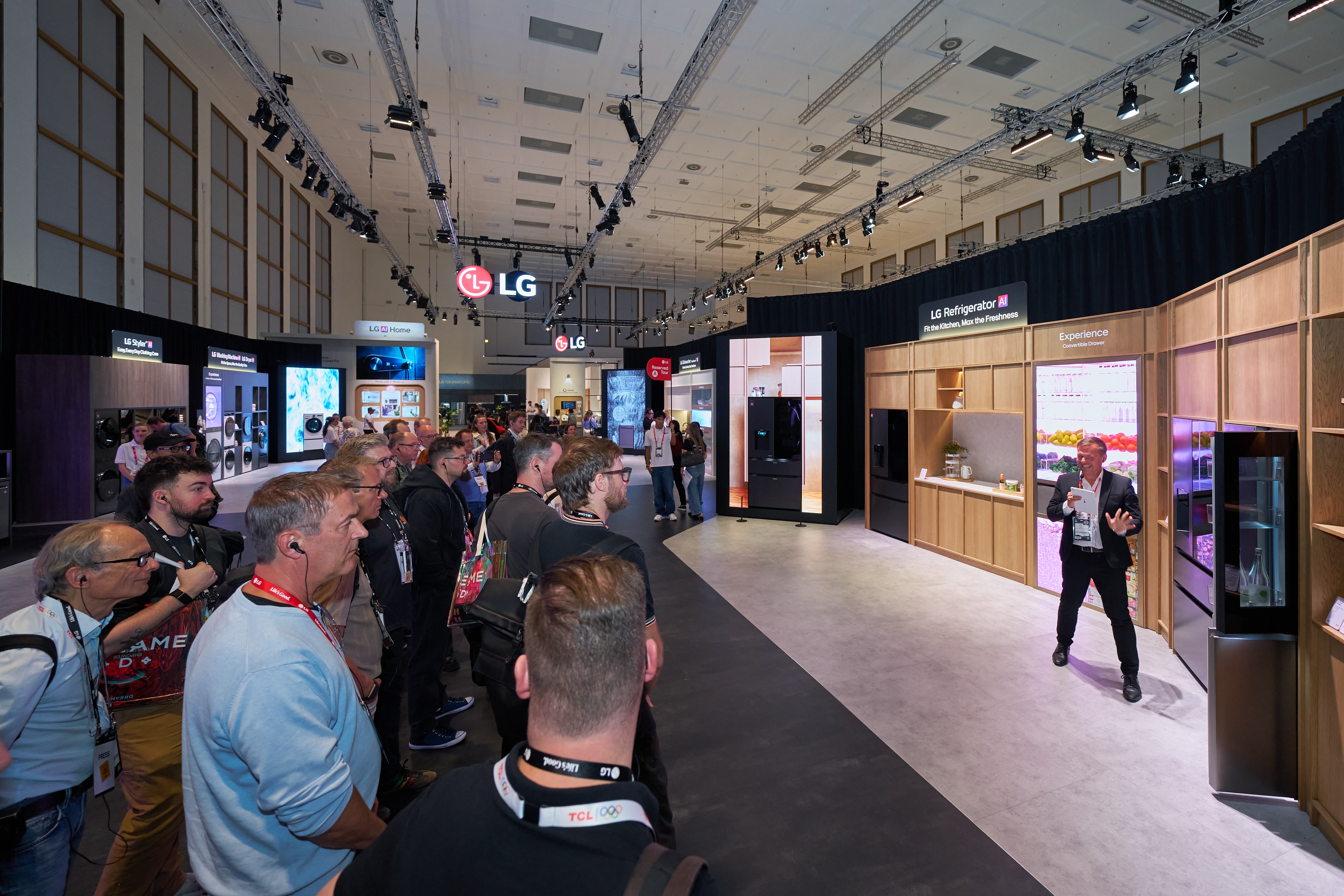 Attendees on the LG media booth tour watch a presenter demonstrate the Fit&Max refrigerators at the LG IFA 2026 exhibition.