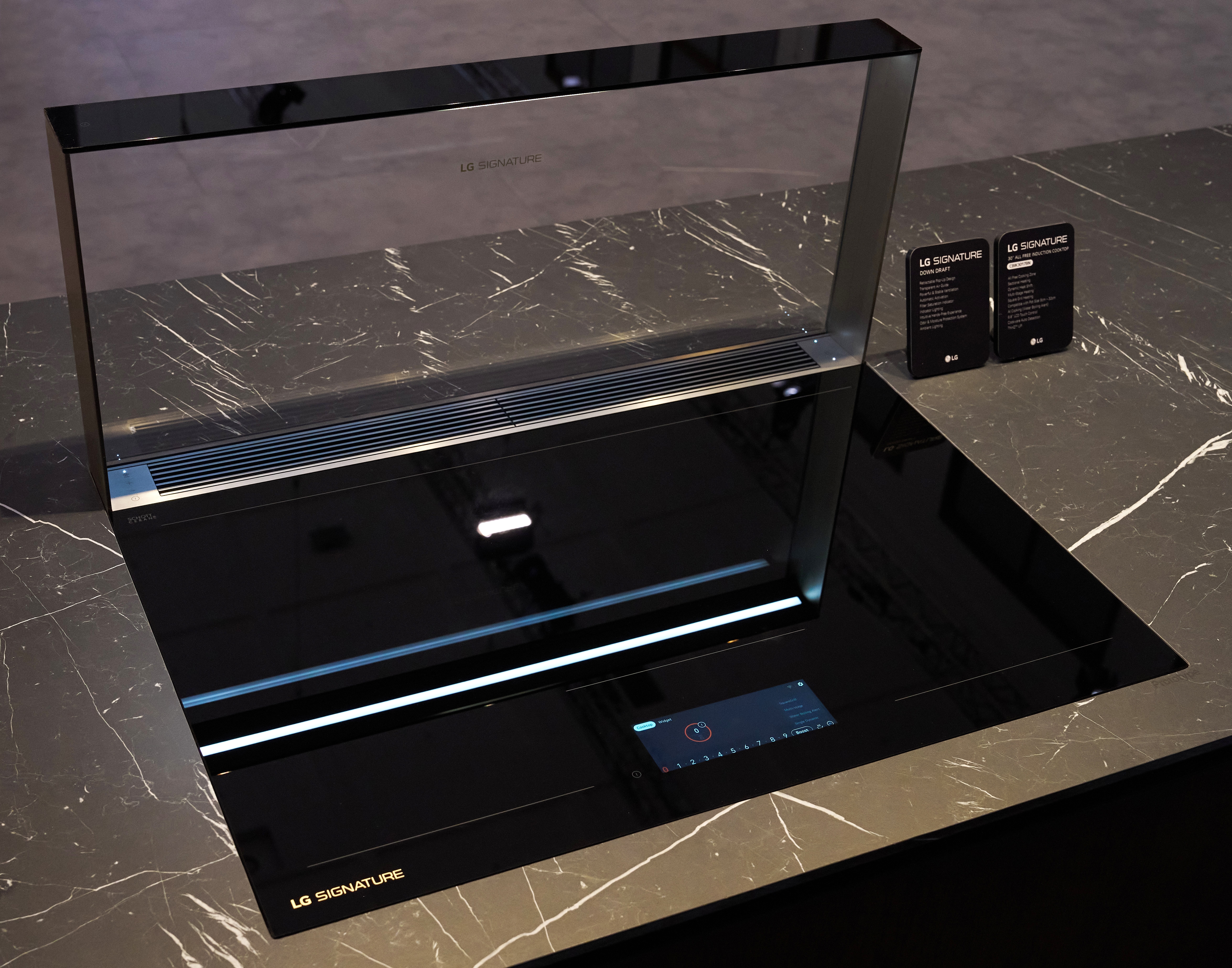 The next-generation LG SIGNATURE downdraft hood is demonstrated at IFA 2026, featuring a minimalist front-glass design that rises from the cooktop and a built-in motion sensor for touch-free convenience.