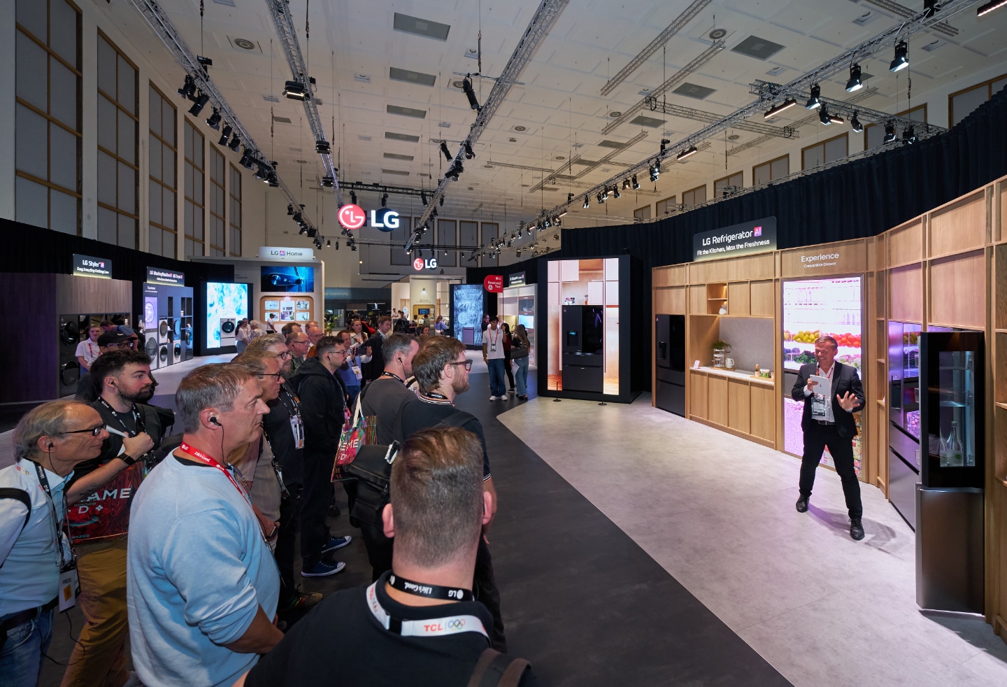 Attendees on the LG media booth tour watch a presenter demonstrate the Fit&Max refrigerators at the LG IFA 2026 exhibition.