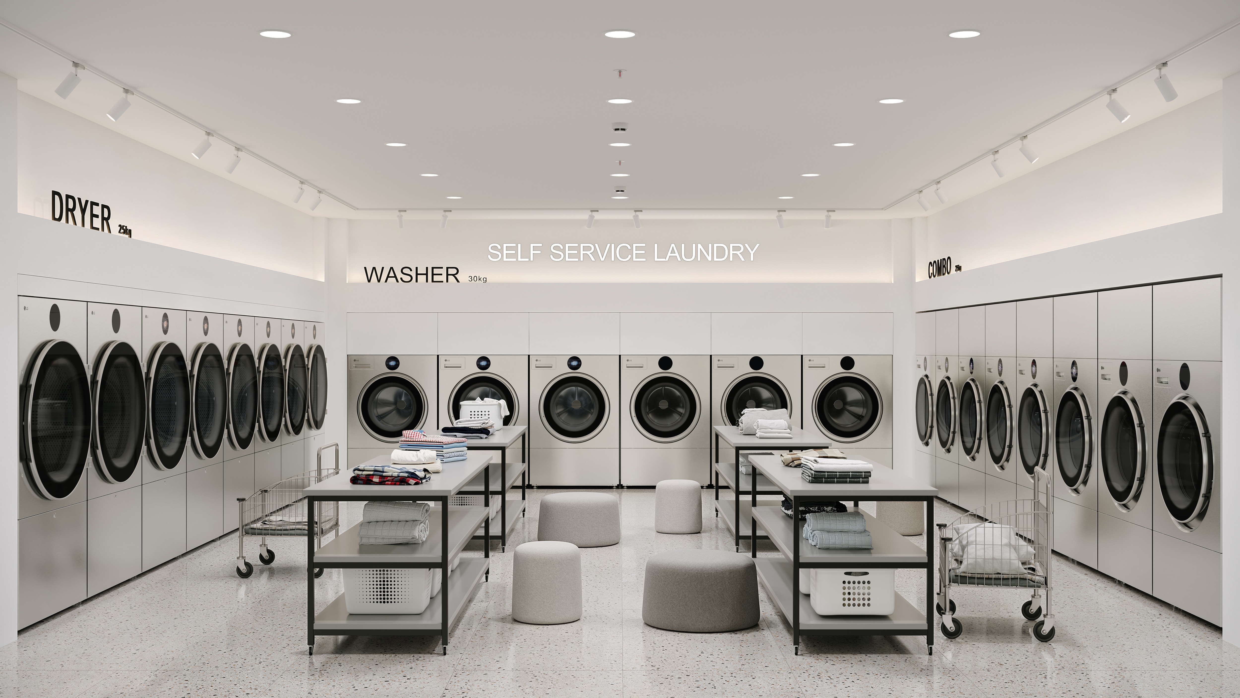 In a bright self-service laundry space, eight LG Professional Dryer units, six LG Professional Washer units and eight LG Professional WasherDryer units are installed along the walls, with folding tables, laundry baskets, carts and seating arranged in the center.