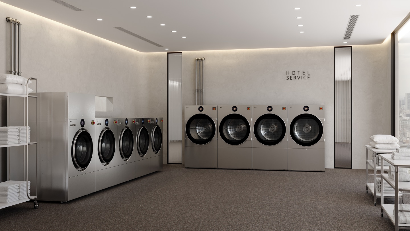 A modern hotel laundry room features, from left to right, one LG Professional WasherDryer unit, four LG Professional Washer units and four LG Professional Dryer units, with utility carts holding folded towels nearby and a “HOTEL SERVICE” sign on the wall above the dryer units.