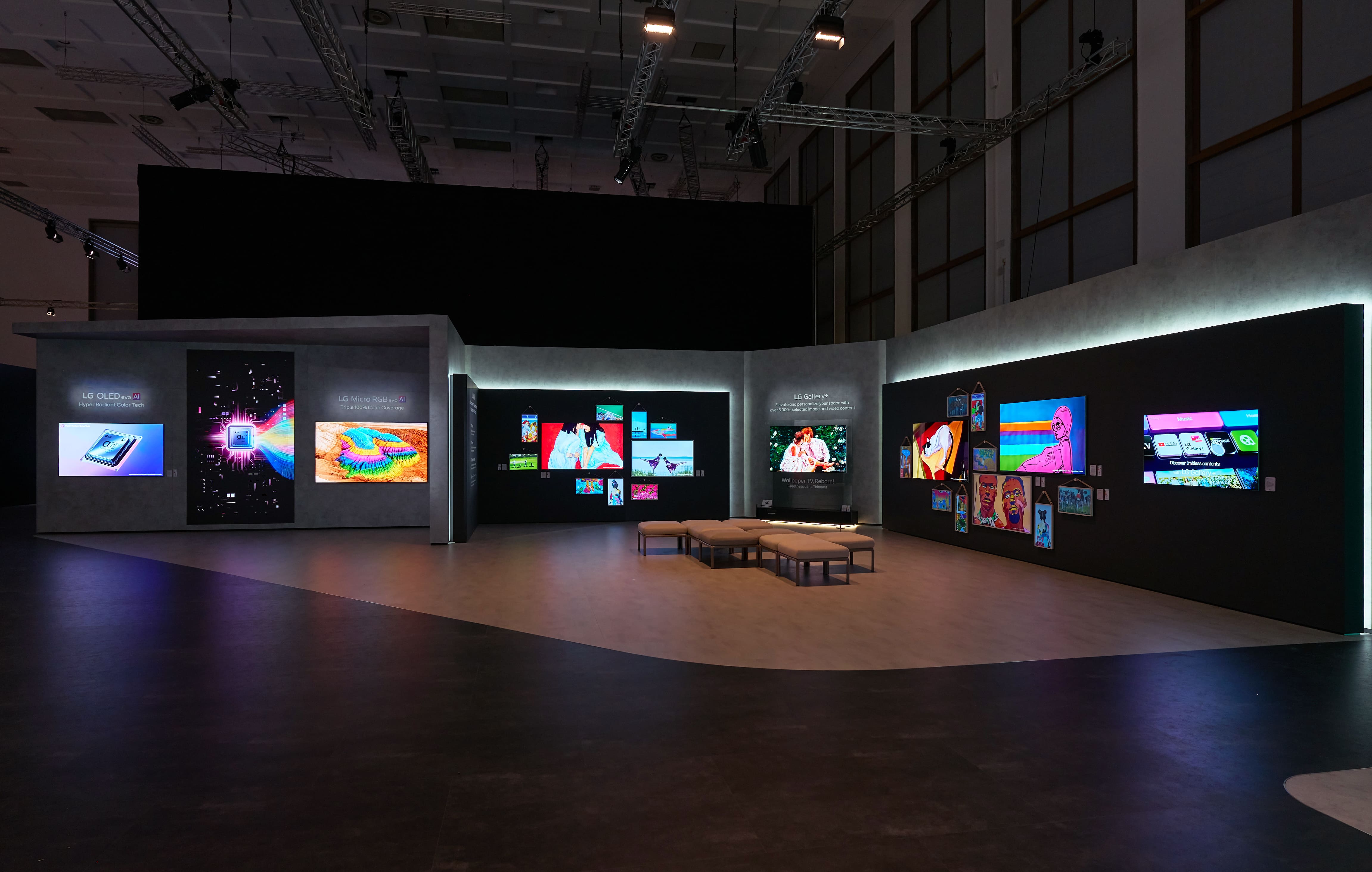 A gallery zone at IFA 2026 featuring digital artworks displayed across multiple screens, with the 83-inch LG OLED evo AI Wallpaper TV at the center.