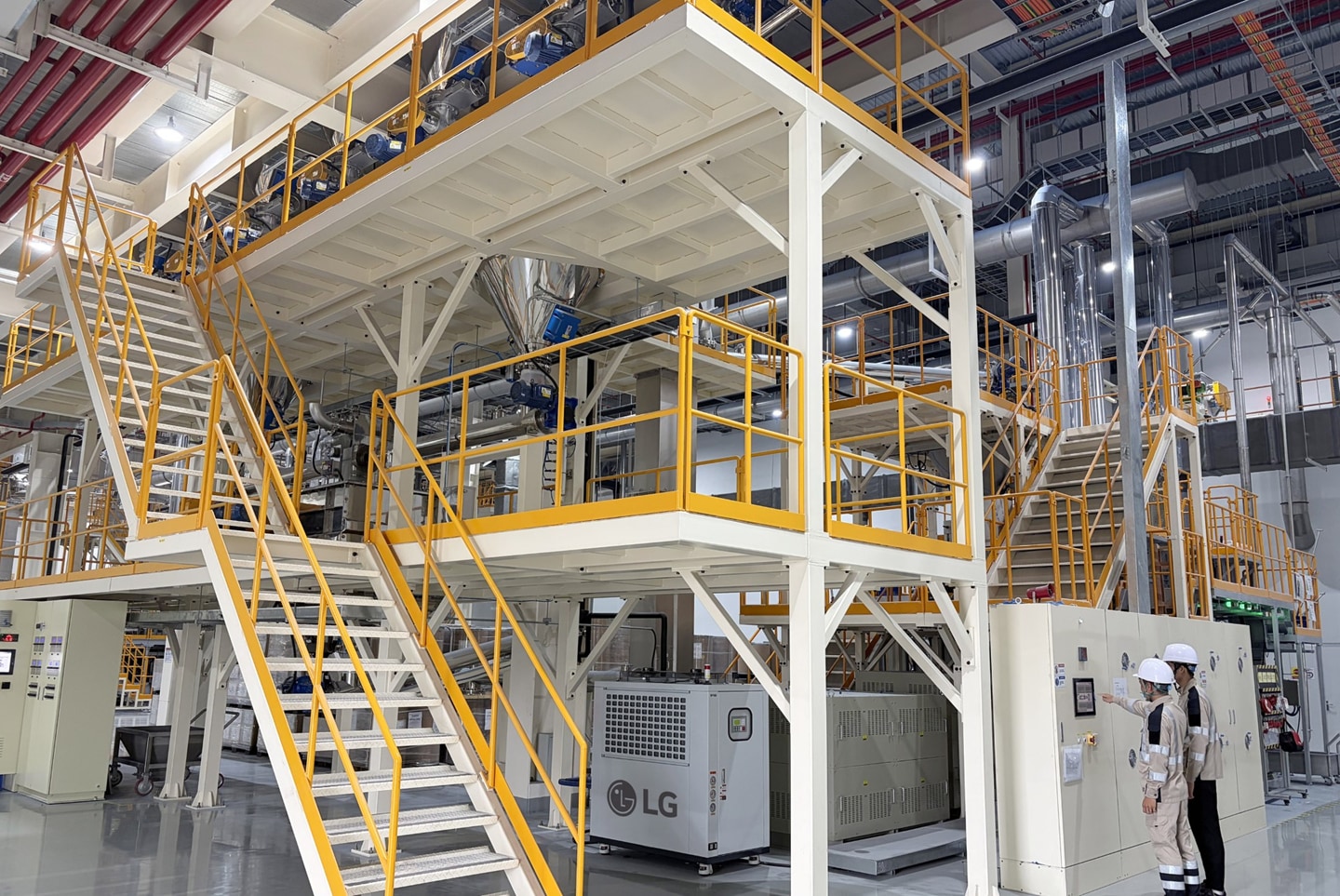 The new production line will produce approximately 2,000 tons of materials annually, including LG PuroTec™ and Easy-Clean Enamel.  Image alt: Employees monitor the advanced glass powder materials production line at LG Electronics' manufacturing facility in Haiphong, Vietnam.