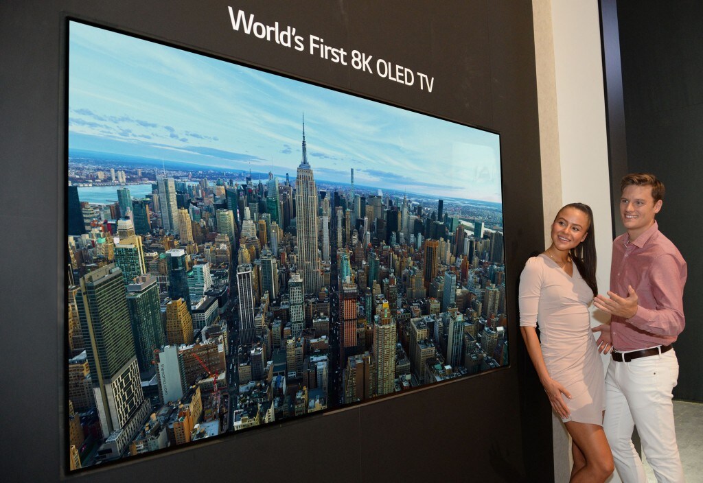 Two models look in awe at the world’s first LG 8K OLED TV displayed at IFA 2018.