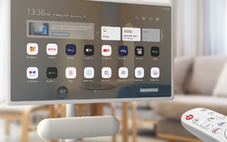 A remote controls an LG StanbyMe and StanbyME Speaker mounted directly under the screen